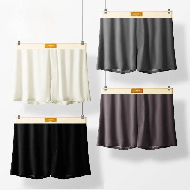 Men's solid colour loose ice silk underwear in beige, black, and grey shades laid flat