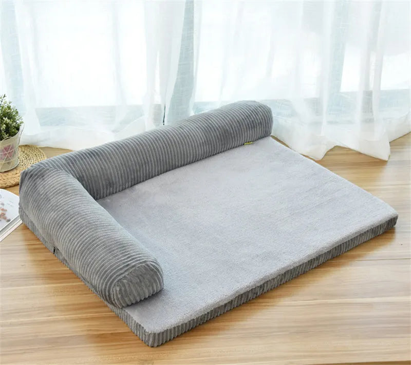 Corduroy bolster dog bed in grey colour, showing its non-slip base and high sides.