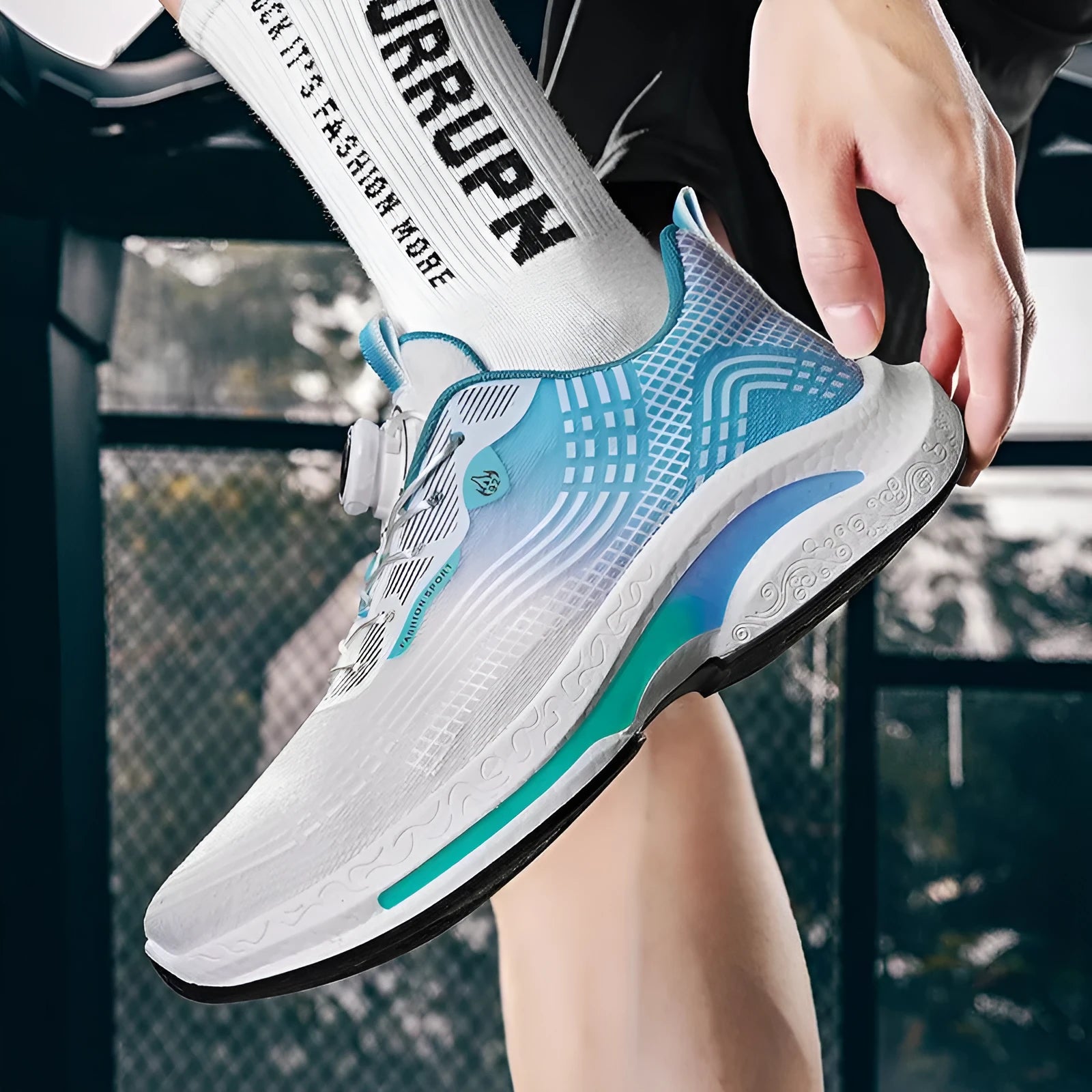 Men's low-top mesh sneaker with a rotating buckle, shown in white and blue colourway.