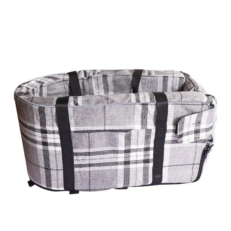A grey cloth outdoor dog kennel set up in a garden, showing its open front and mesh panel.