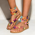 Women's ethnic beaded petal sandals in synthetic PU leather with floral design and round toe.