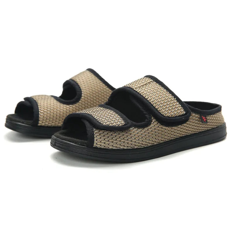 Wide puffy adjustable slippers with mesh upper and rubber sole in black colour