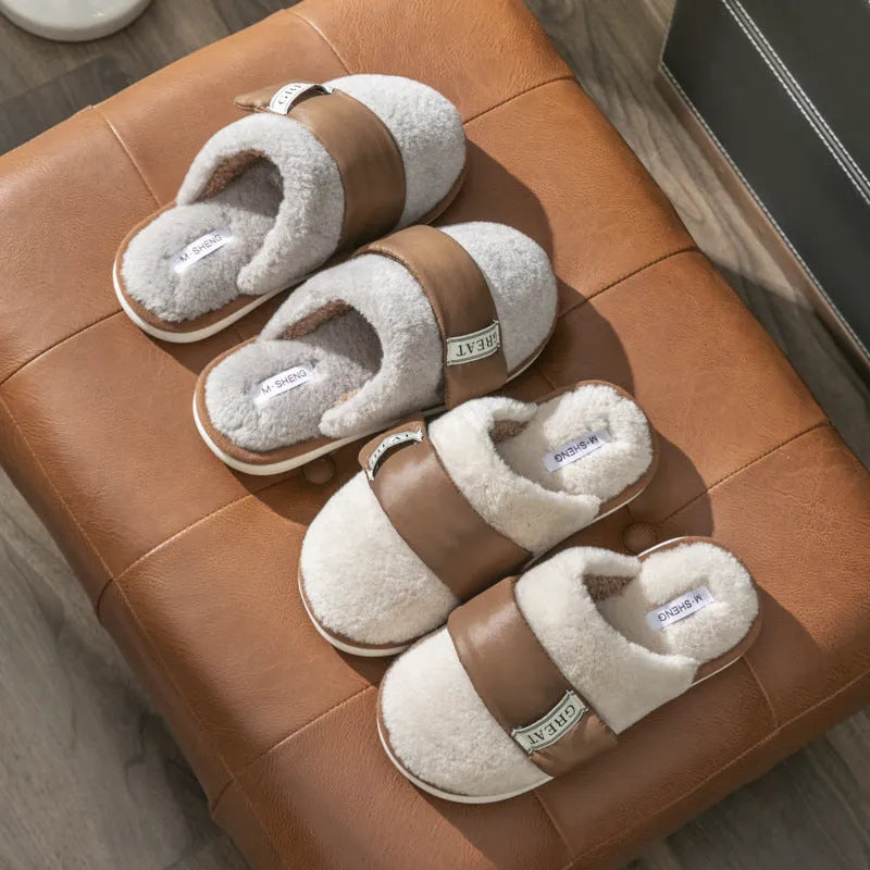 Beige women's plush slippers with a Velcro strap and non-slip plastic sole on a wooden floor.