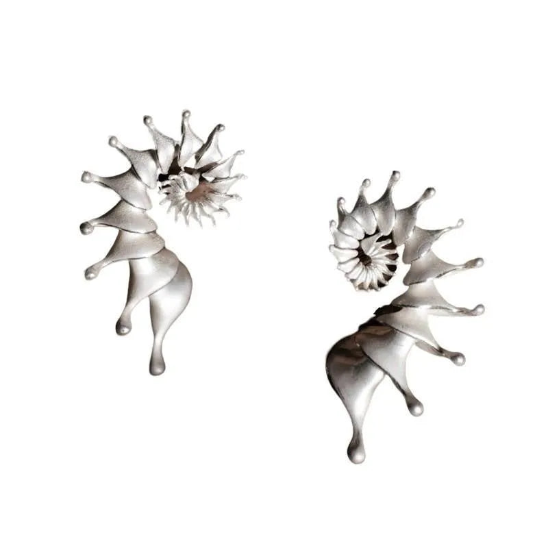 Exaggerated three-dimensional matte conch ear studs in alloy with an irregular simple style.