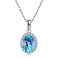 Women's four-piece sterling silver jewellery set with blue topaz gems, showing geometric earrings, ring, pendant and necklace.