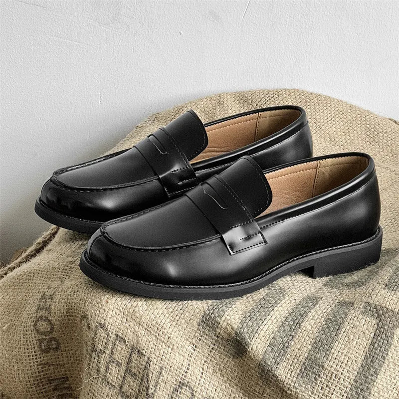 Men's black slip-on derby shoes with rubber sole showing height increasing feature