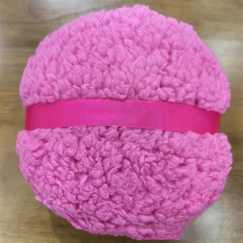 Large rectangular plush makeup powder puff in white on pink background.