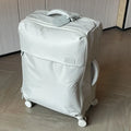 Tea brown coloured ultra-light waterproof Oxford cloth wheeled luggage suitcase in a 20-inch size.