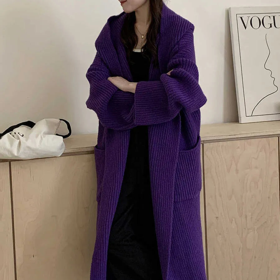 Loose grey hooded cardigan coat for women with raglan sleeves on a hanger