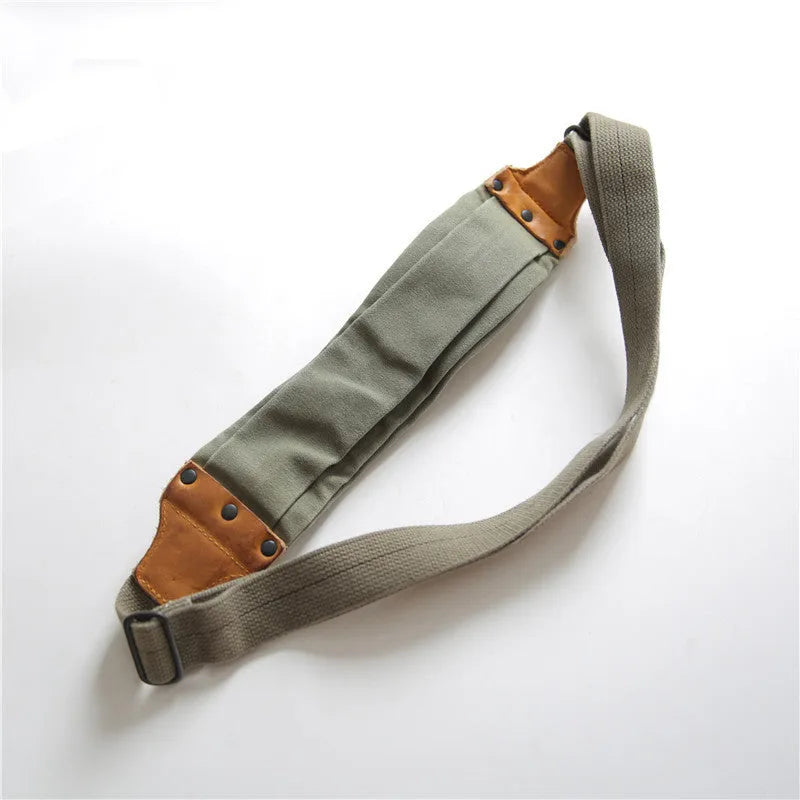 Green military style chest bag made from canvas with leather accents and anti-theft functionality
