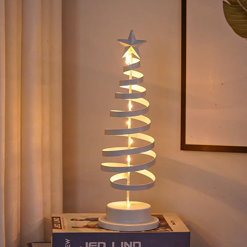 Wrought iron metal LED Christmas tree spiral light with warm white illumination on tabletop