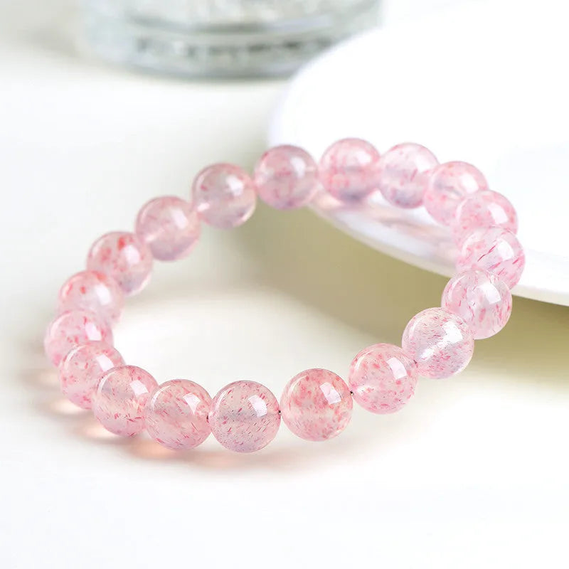 Natural white water strawberry quartz crystal ball bracelet with geometric beads.