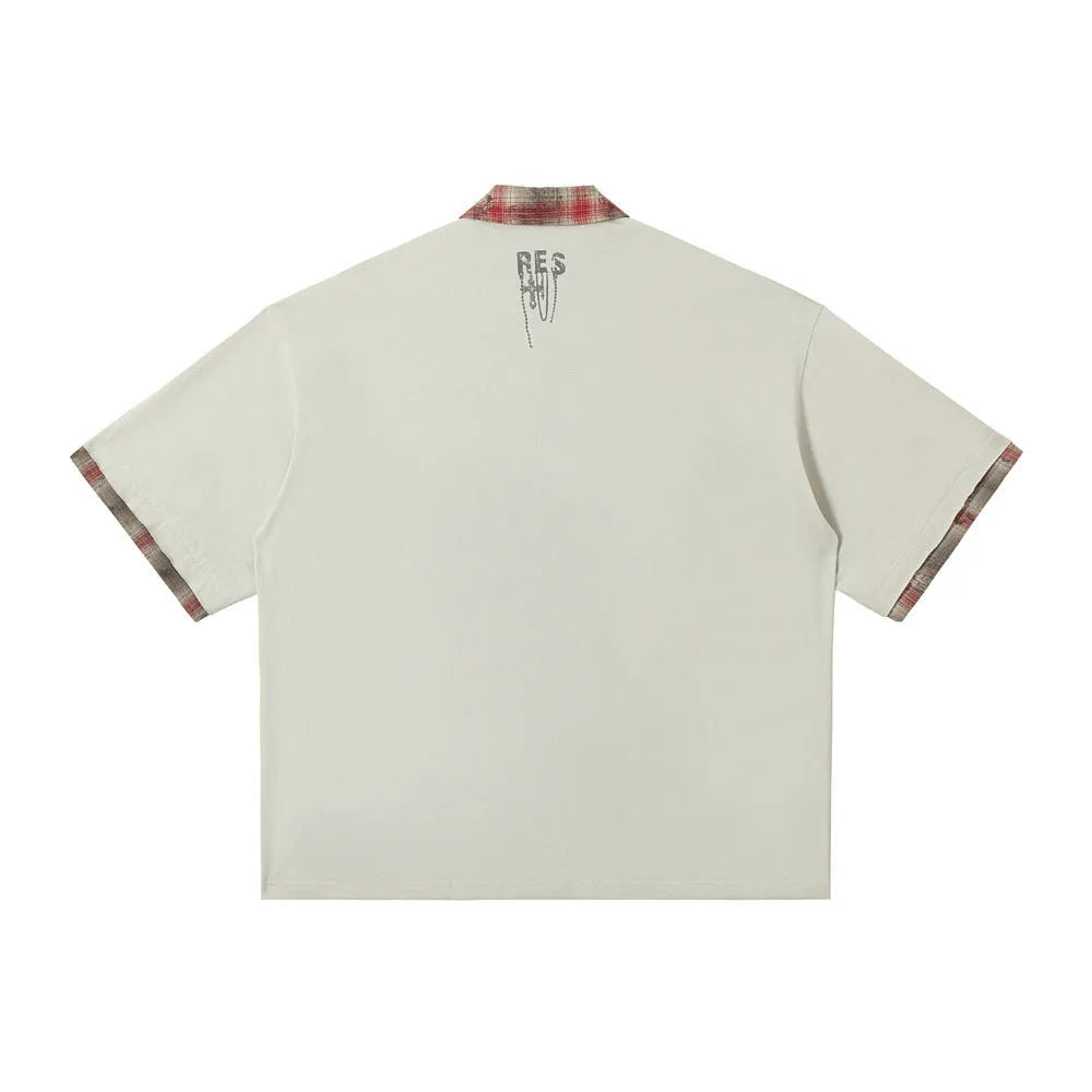 Men's loose blue cotton short-sleeve top with asymmetric cut and graffiti print on lapel.