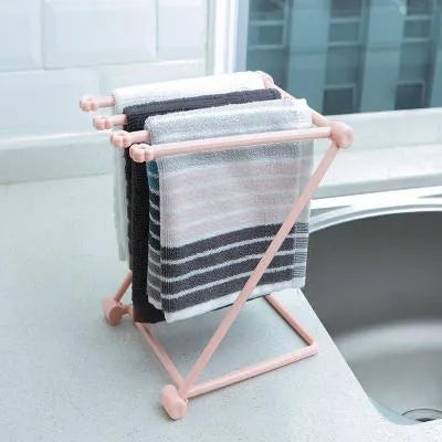 Foldable light grey plastic dishcloth shelf with vertical design mounted on a wall