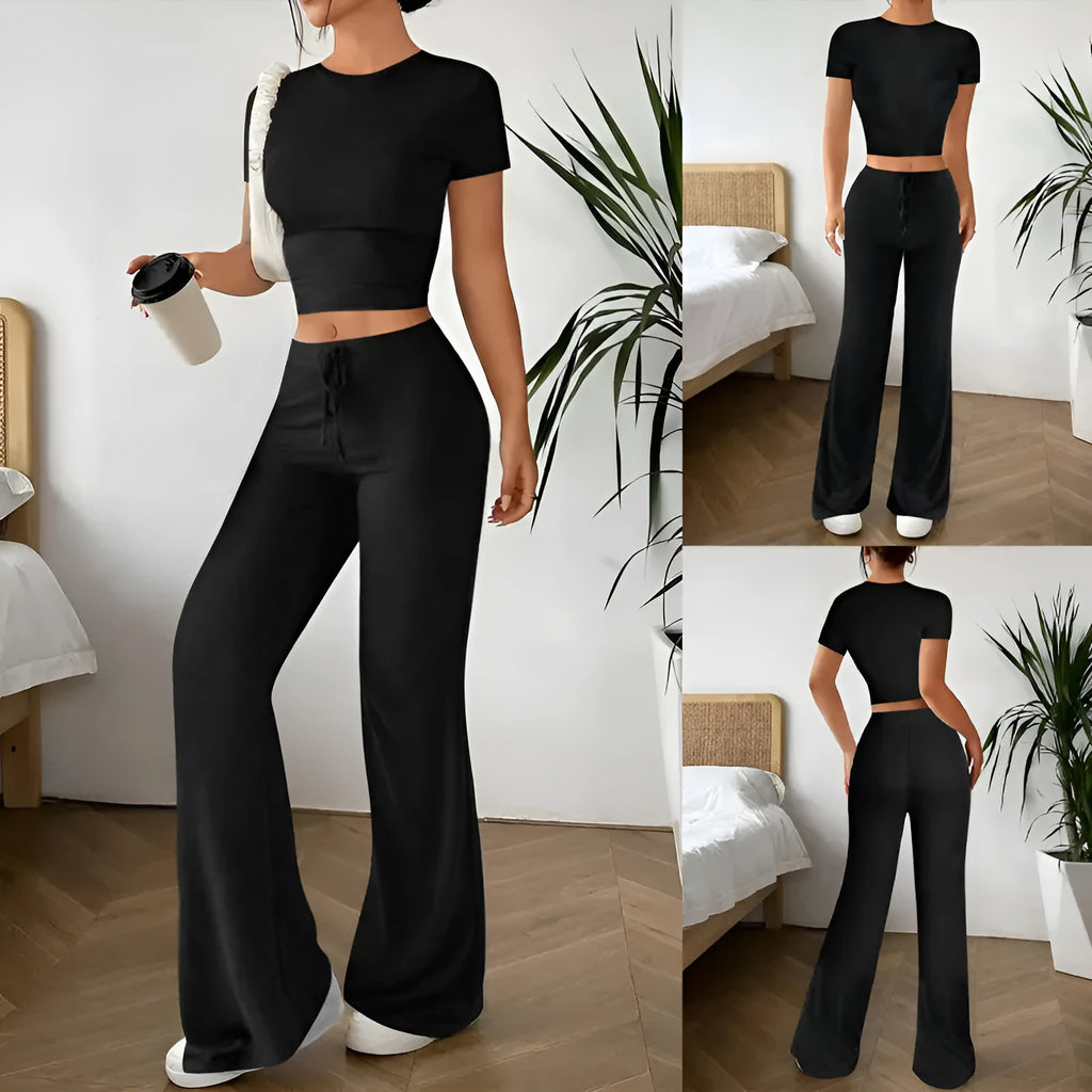 Black women's polyester trousers suit with high-waist trousers and a short-sleeve T-shirt on a hanger.