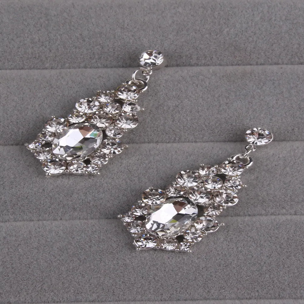 Alloy crystal rhinestone necklace and earring set with butterfly dragon serpent pattern on white background