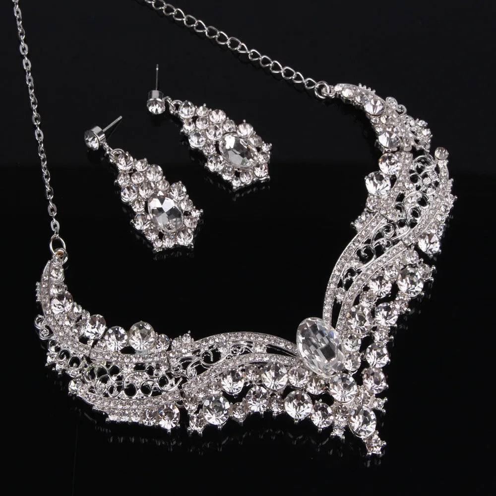 Alloy crystal rhinestone necklace and earring set with butterfly dragon serpent pattern on white background