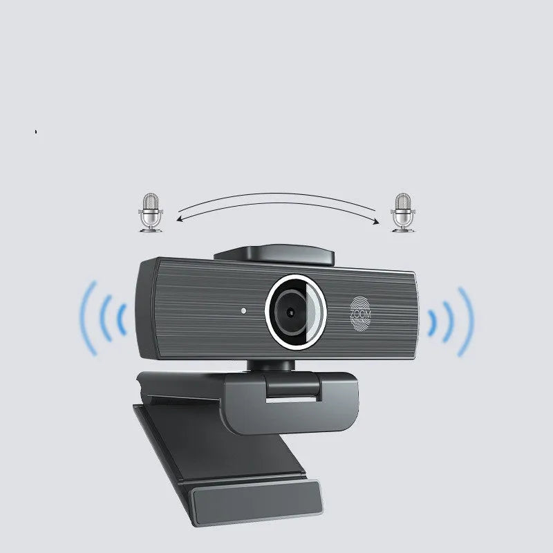 Black ABS plastic USB computer webcam with a detached magnetic privacy cover on a desk.