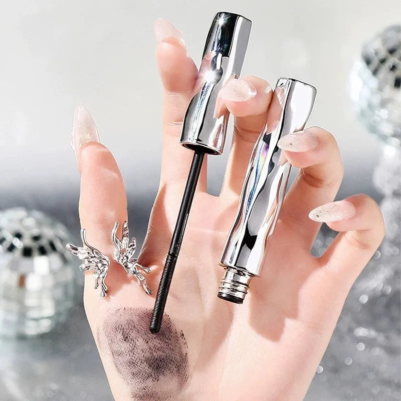 Black waterproof mascara in a steel tube, shown with an eyelash curler option.