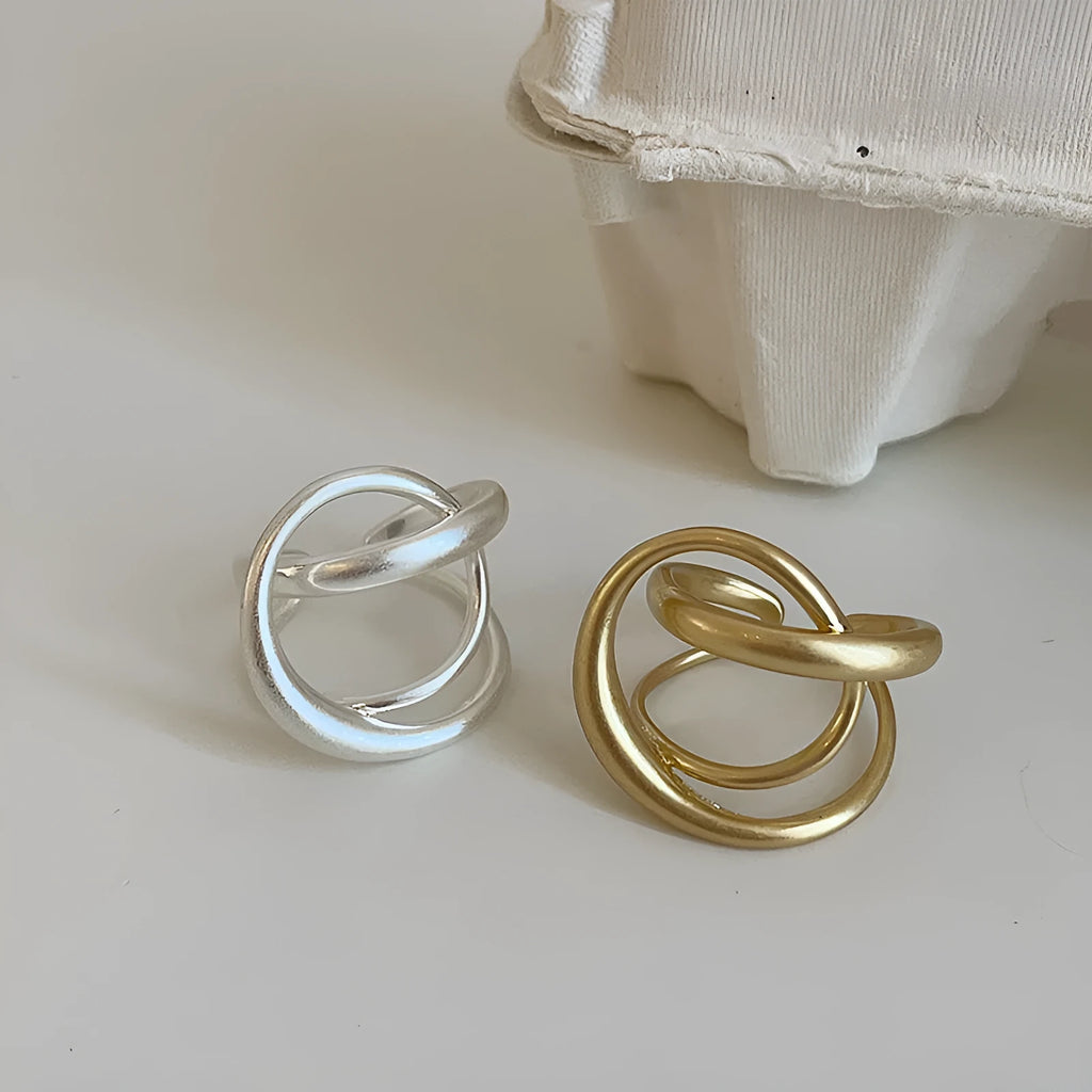 Geometric interlaced matte metal open ring for women in gold or silver colour.