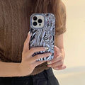 Soft TPU iPhone case with a textured three-dimensional pleated pattern in an electroplated silver finish.