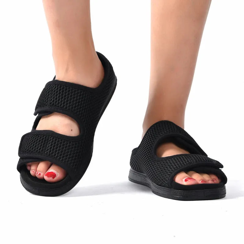 Wide puffy adjustable slippers with mesh upper and rubber sole in black colour