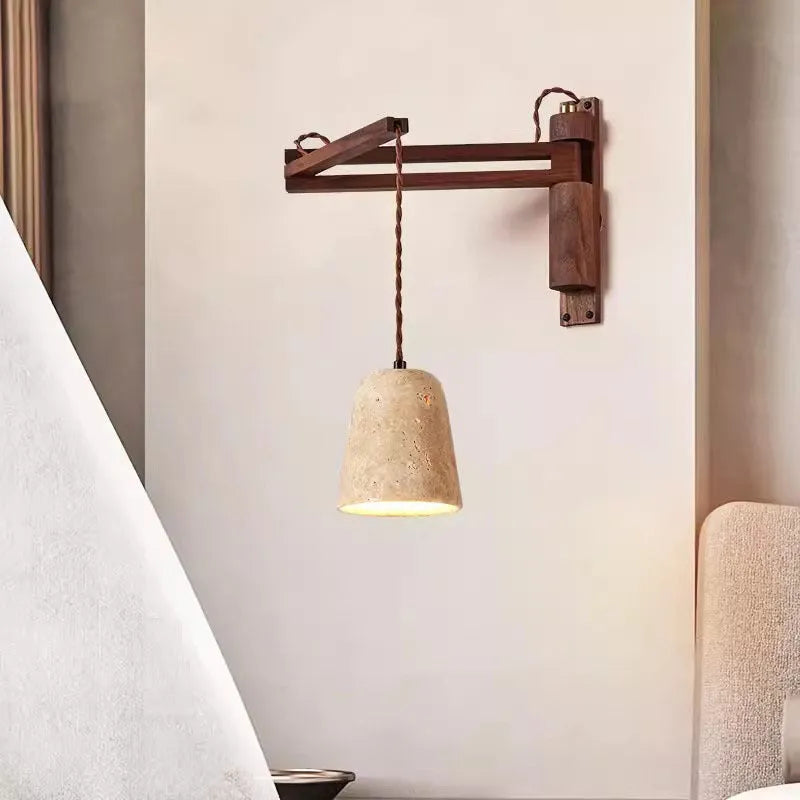 Yellow cave stone wall lamp with textured finish installed above bedside table