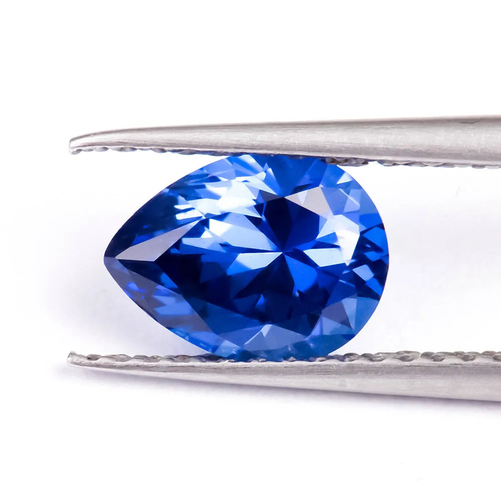 Loose blue heart-shaped cultivated sapphire gemstone on a jewellery cloth.