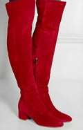Grey suede women's over-the-knee flat boots with a pointed toe and low thick heel on a neutral background.