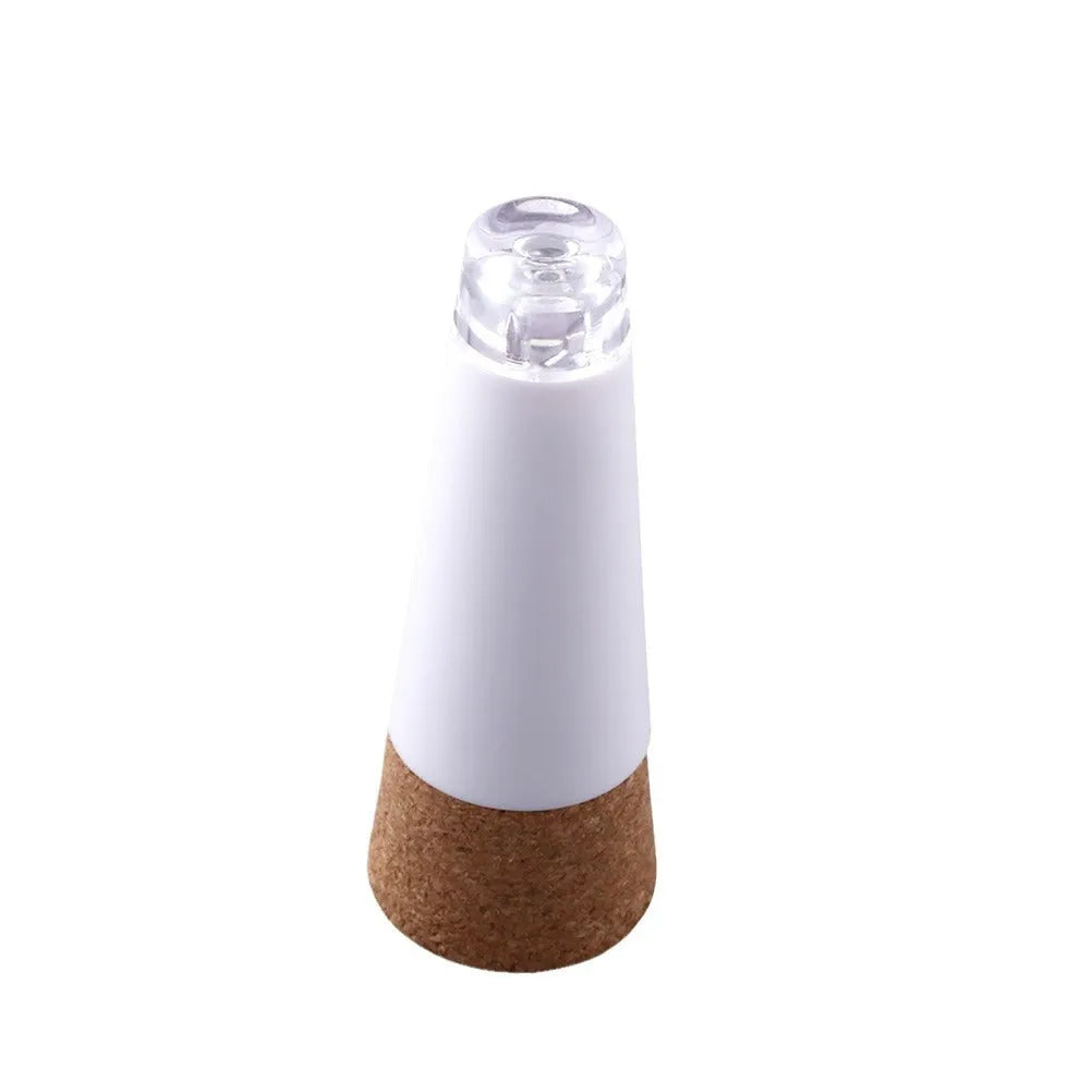 White plastic LED bottle cap light with 15 LEDs, shown on a glass bottle neck.