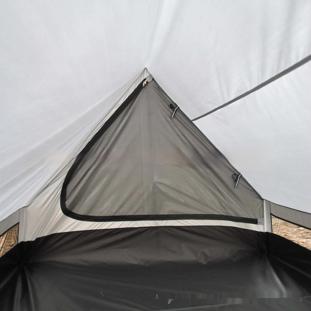 Brown A-line hiking tent pitched using trekking poles with guy ropes secured