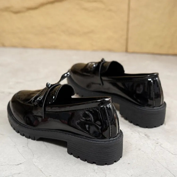 Brown women's flat loafers with a decorative bow on the front.