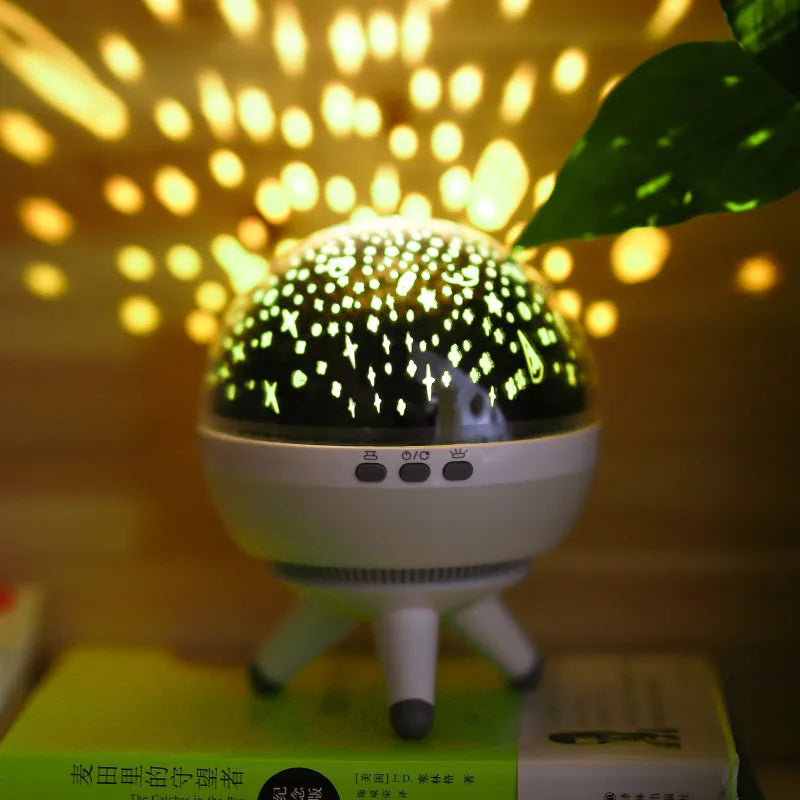Rotating starlight projection lamp in black or white with cartoon style design and battery power