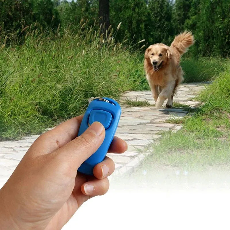 Colourful plastic dog training clicker with whistle and key ring on a white background.