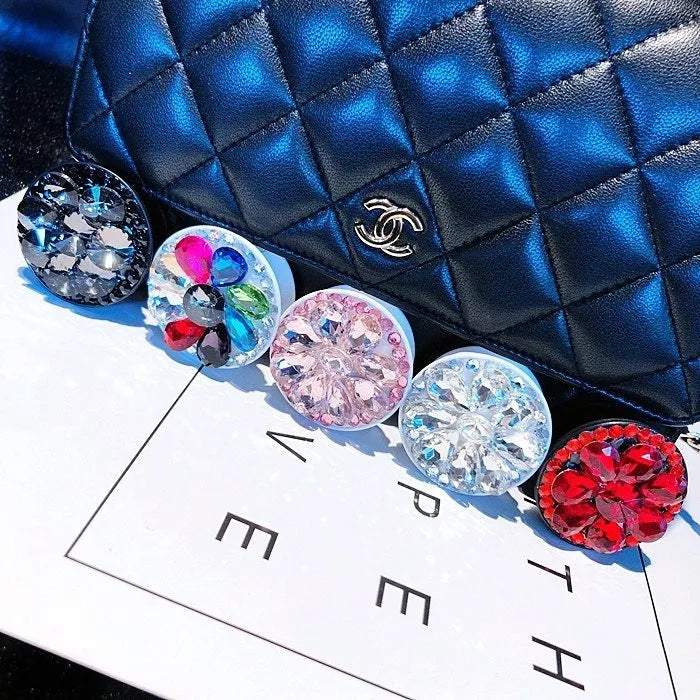 Rhinestone-decorated airbag-style car phone holder with telescopic bracket extended, showing 360-degree swivel mechanism.