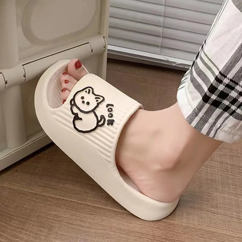 Women's green cat-themed platform slippers with non-slip EVA sole on a wooden floor.