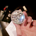 Rhinestone-decorated airbag-style car phone holder with telescopic bracket extended, showing 360-degree swivel mechanism.