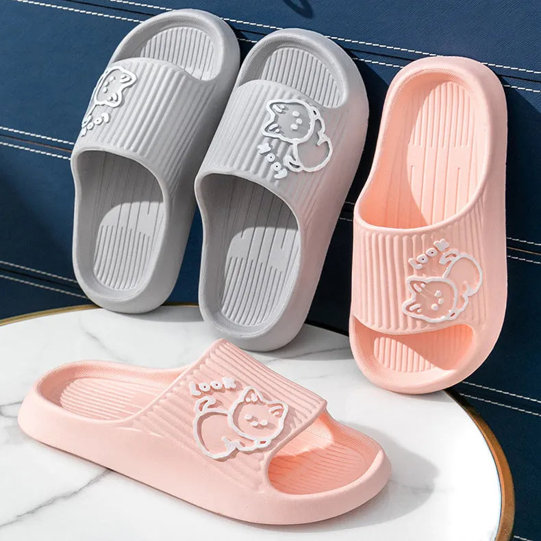 Women's green cat-themed platform slippers with non-slip EVA sole on a wooden floor.