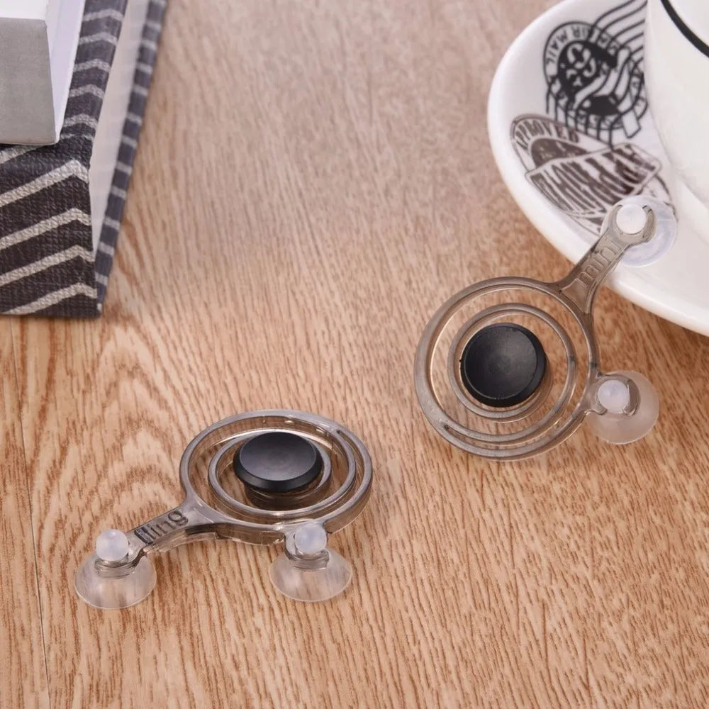 A pair of clear and black mini joysticks for mobile phone touch screen gaming.