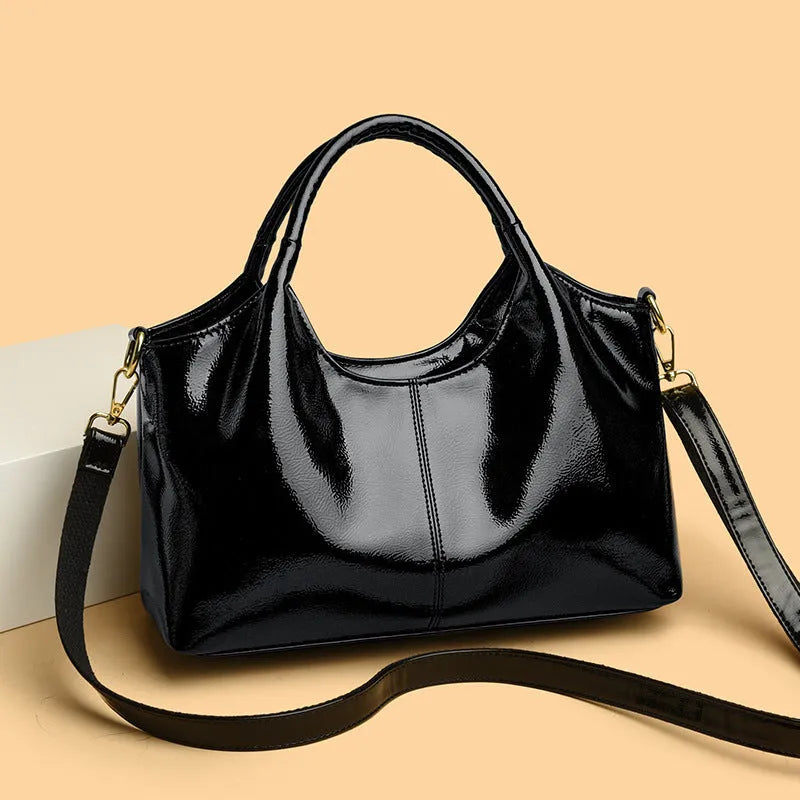 Genuine leather commuter bag with glossy finish, belt decoration, and leather grain in a horizontal square shape