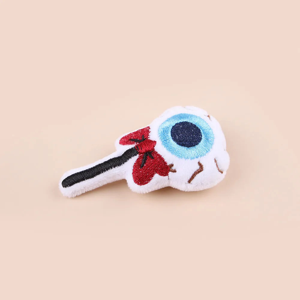 Small plush cat teaser wand with colourful eyes, candy and skull shaped attachments