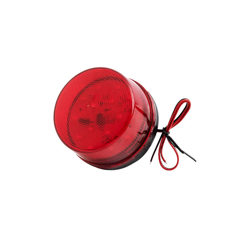 Small red 24V flashing warning light and alarm with mounting base.