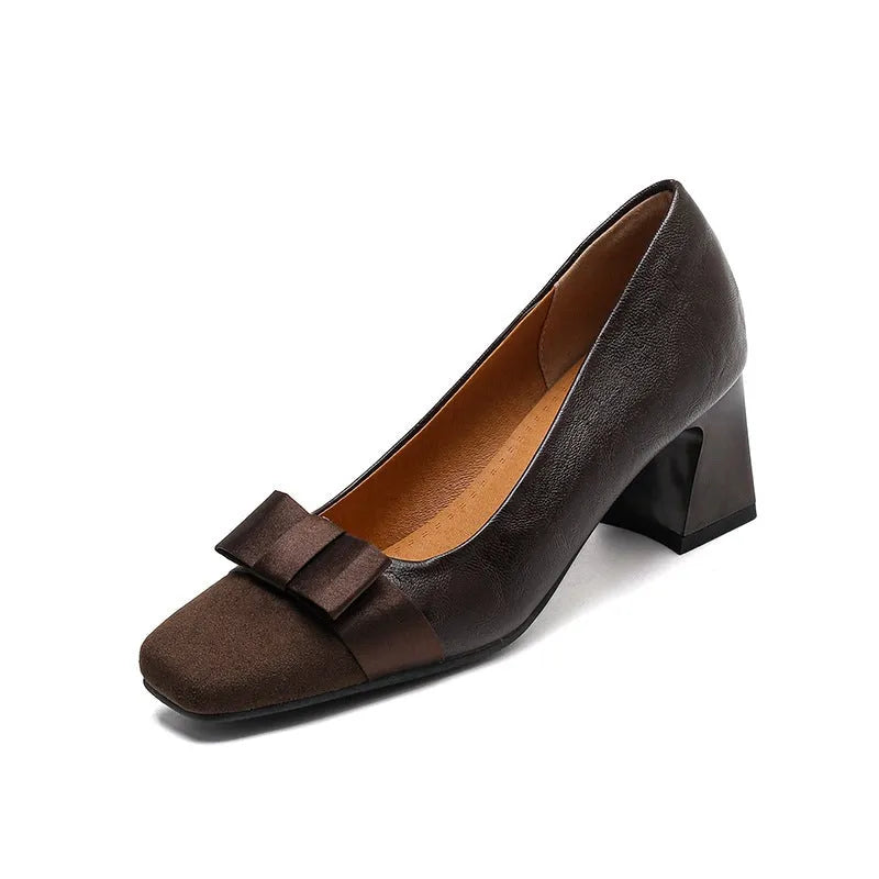 Retro square toe chunky heel pumps for women in black, with bow detail and low-cut design on a light background