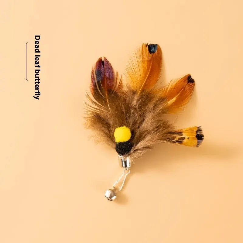 Three small steel-wire insect toy heads for cats in assorted colours, against a white background.