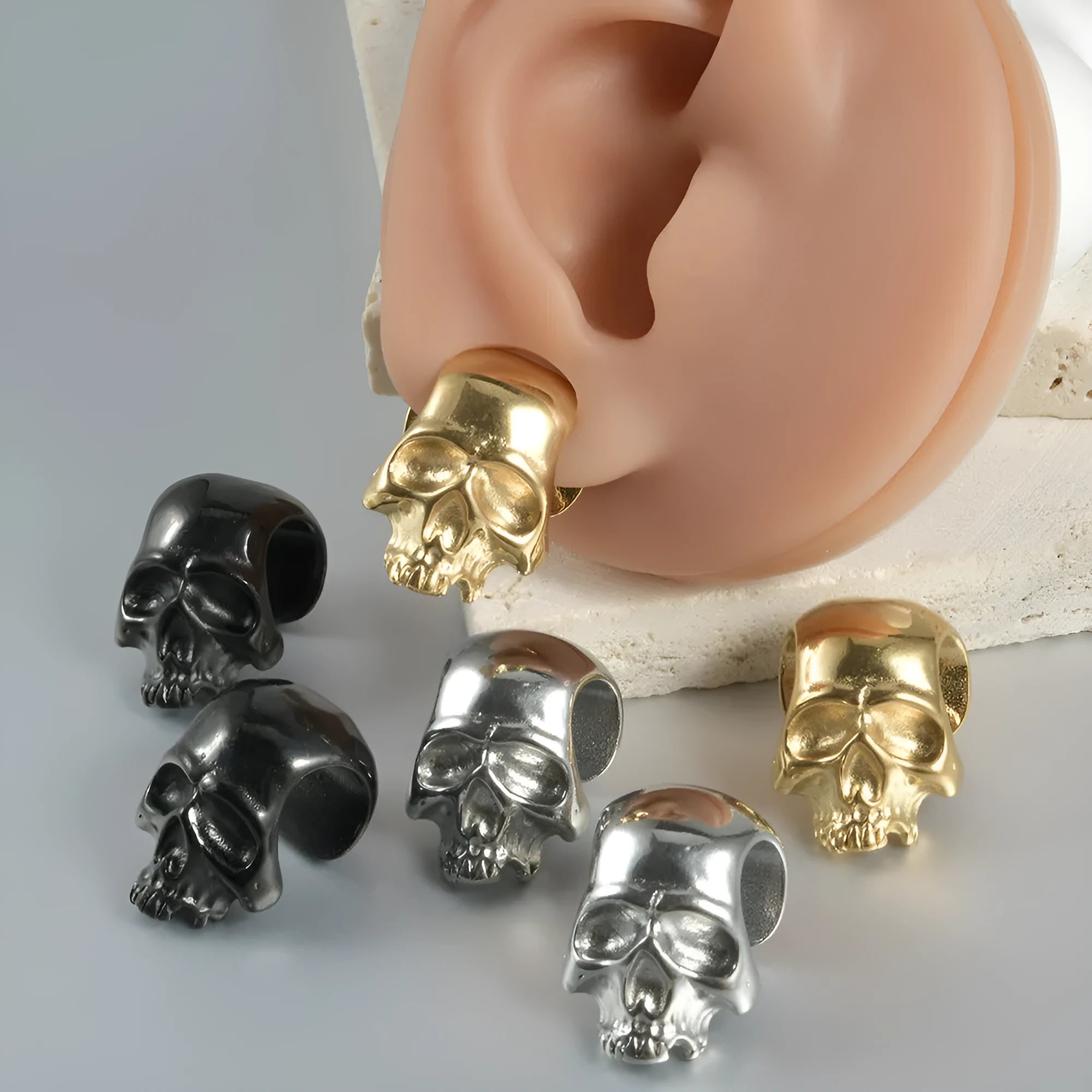 Stainless steel hollow skull and Buddha geometric earrings in electroplated colours.