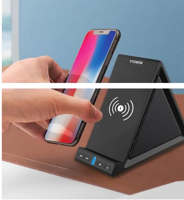 Black multifunctional Bluetooth speaker with integrated mobile phone stand and wireless charging pad on a desk