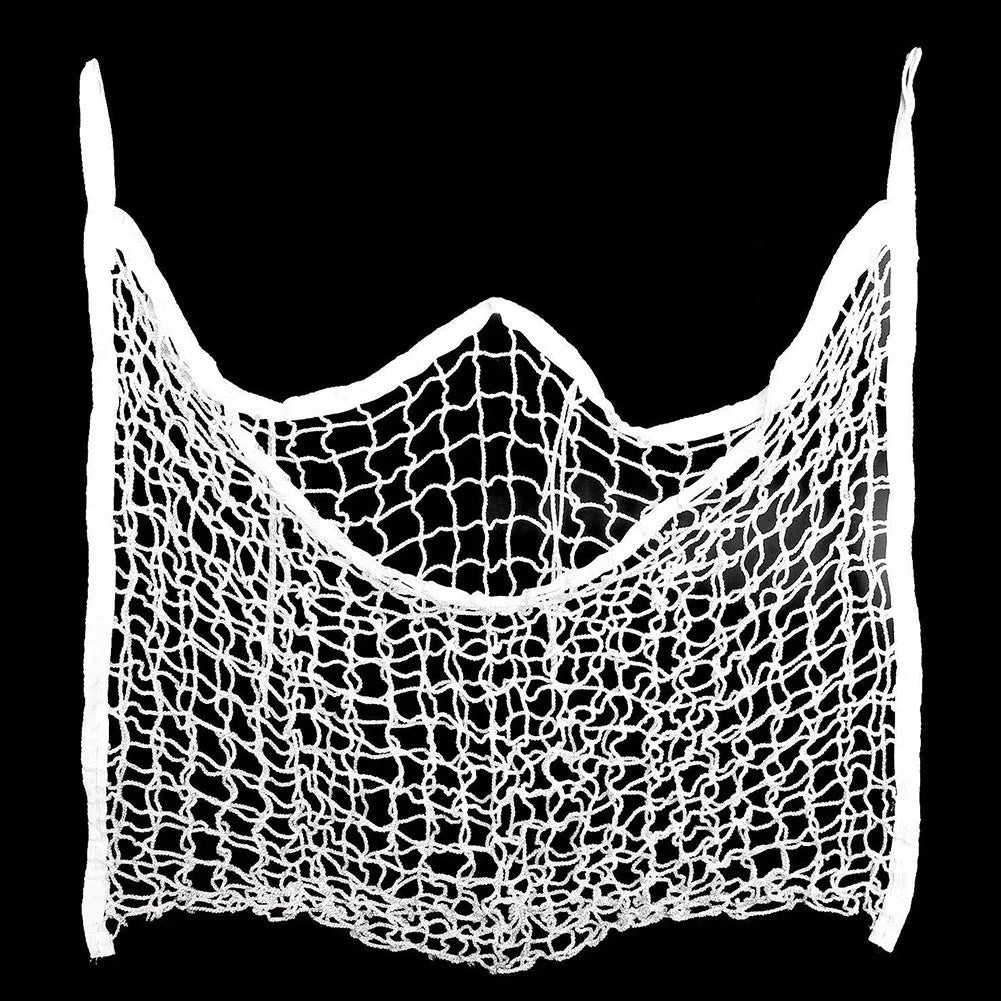 Black woven grid horse feeding bag hanging, filled with hay.