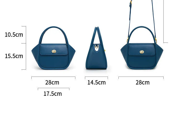 A women's leather wing-shaped tote bag with a metal latch, shown in blue on a cross-body strap.