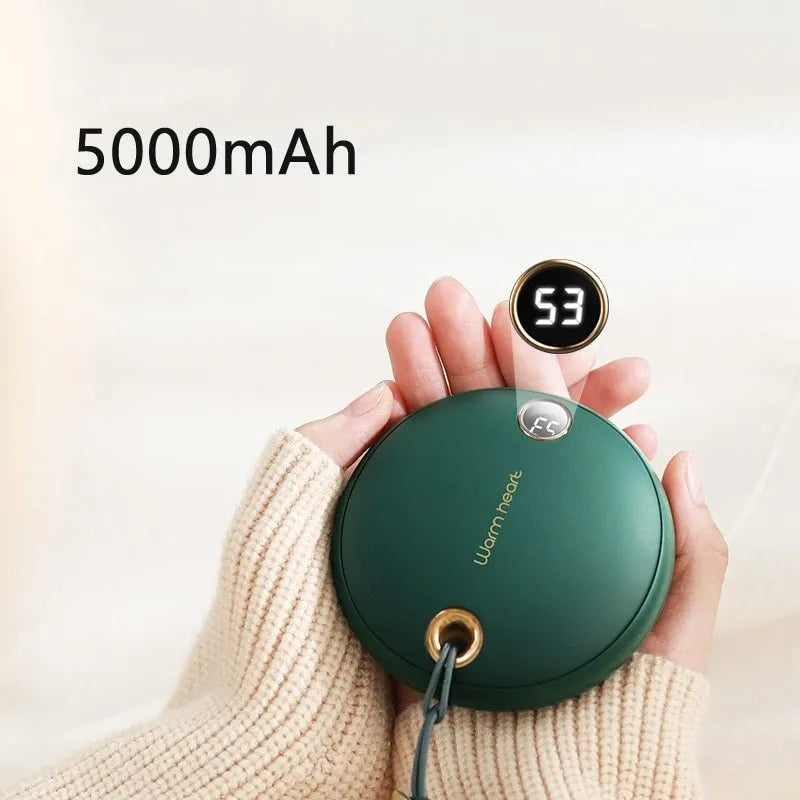 Green hand warmer power bank with digital display showing charge level, next to a charging cable.