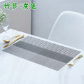 Modern PVC placemat in gradient bamboo design on a wooden dining table.